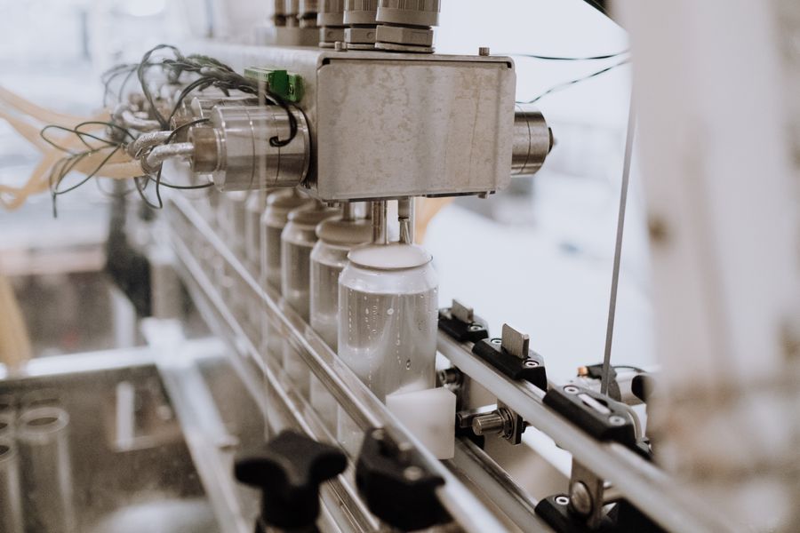 Automated production line machinery filling and processing products in a factory